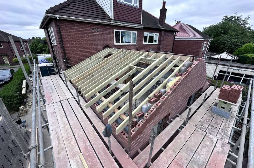 new roof with window openings on the extension