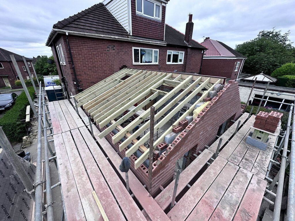 new roof with window openings on the extension